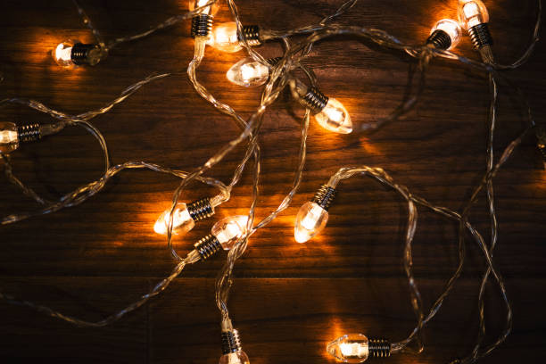 istock Christmas lights on the wooden background. 1188921067