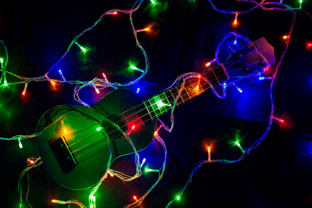 istock Colored lights of garlands and ukulele close-up. 1188921104