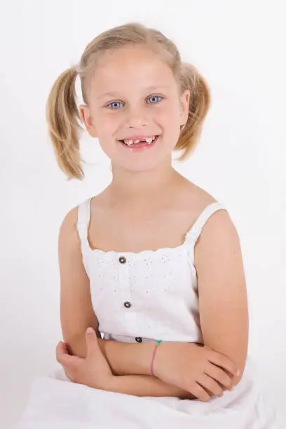 7 year old blond Girl smiling at the camera portrait on white background