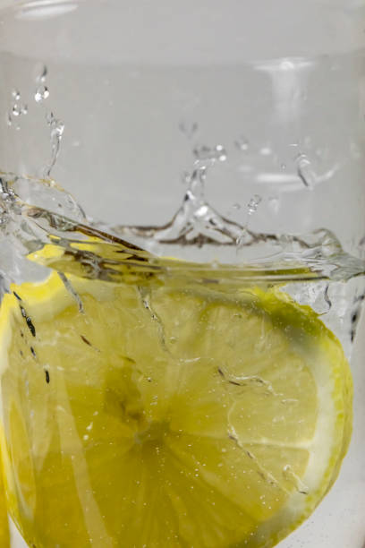 istock close up of Lemon splashing into a glass 1188923213