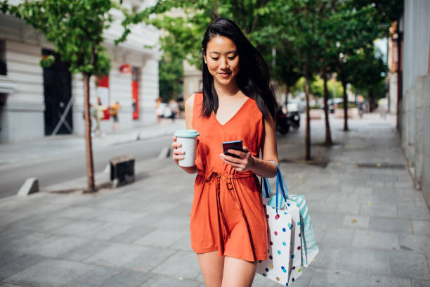 Beautiful Asian girl going back from shopping