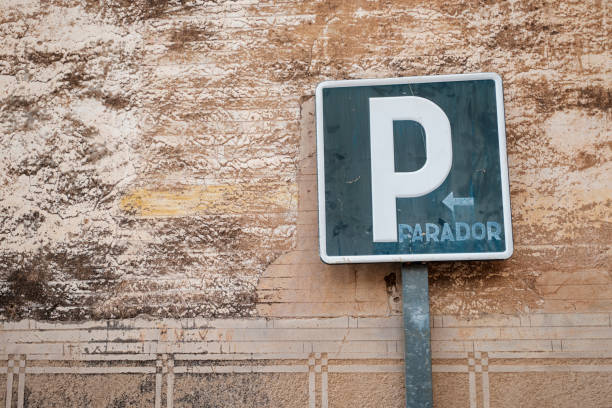 old weathered parking traffic sign against a stucco old wall - sign rusty industry no parking sign imagens e fotografias de stock