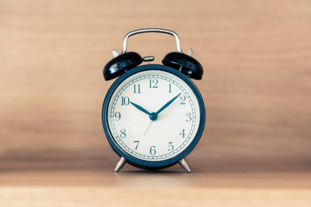 istock Black alarm clock on the headboard bed shelf with sunlight 1188924662