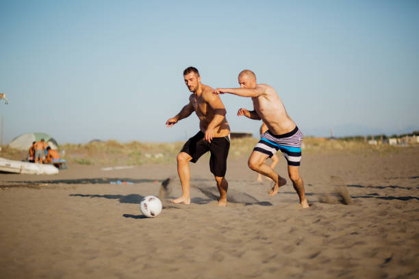 istock Young men playing football 1188925343