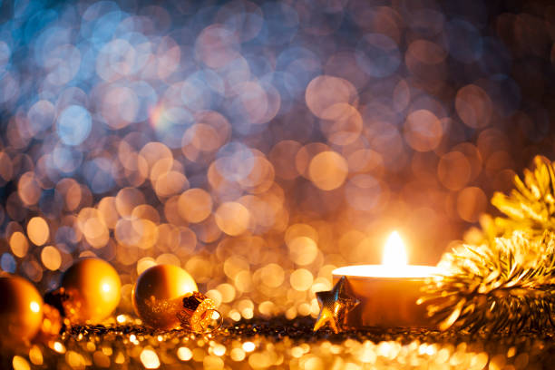 istock Lighted candle on defocused blue background - Christmas Tea Light 1188925896