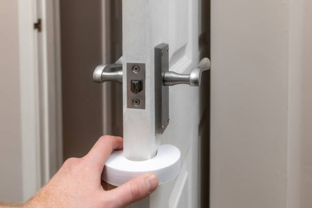 istock Putting on a foam door stop - child proofing the home 1188928595