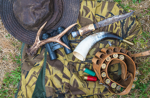 Hunting equipments: deer atler, hunting horn, hat, cartridges. Flat lay