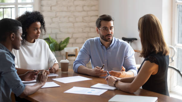 istock Concentrated employees listening to boss project instruction. 1188929910