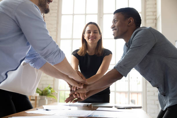 istock Leader motivating young mixed race colleagues before starting new project. 1188929921