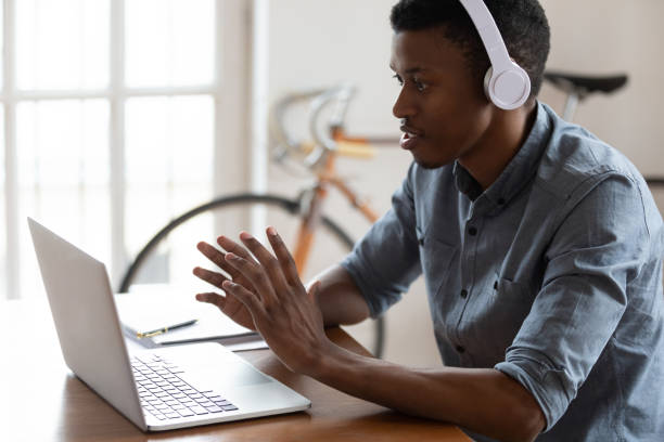 istock Motivated millennial mixed race employee discussing project with client. 1188929941