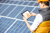 Examining production of solar power plant with digital tablet