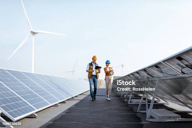 Engineers On A Solar Power Plant Stock Photo - Download Image Now - Fuel and Power Generation, Engineer, Solar Panel
