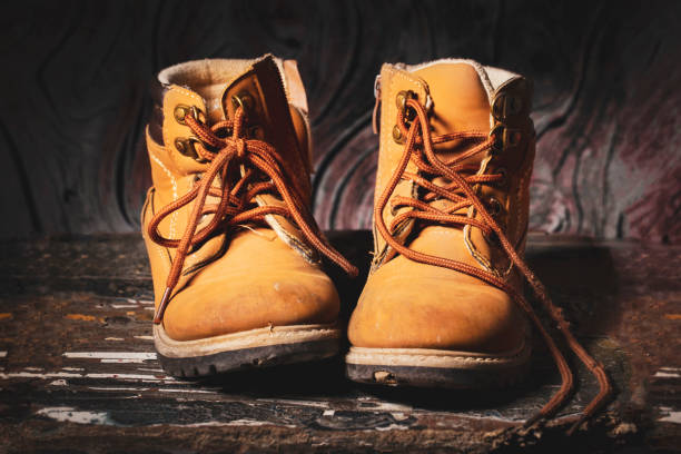 istock Old boots on vintage background.Baby worn shoes 1188931729