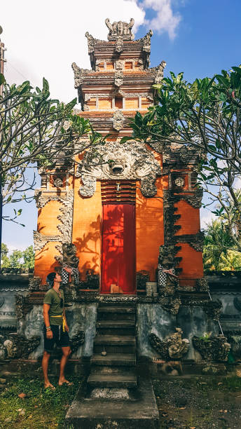 istock Lombok - A man standing under the temple 1188931837