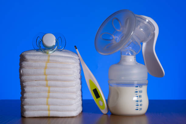 istock breast pump and nappies and thermometer with a pacifier on a blue background 1188932021