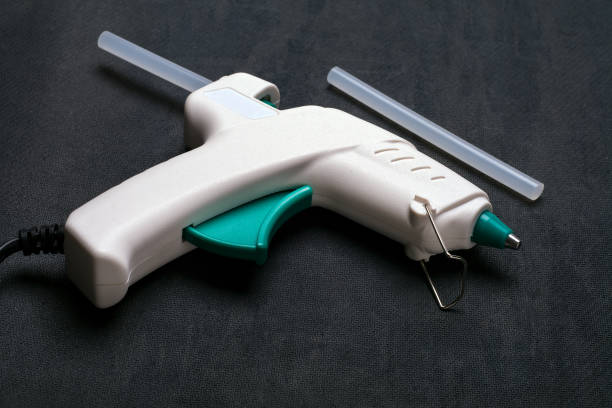 istock glue-gun on the black background 1188933740