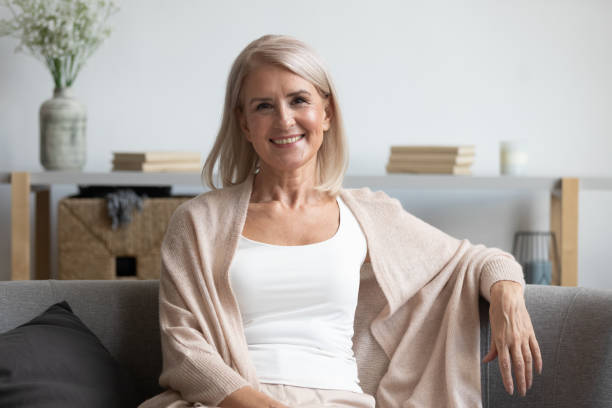 istock Happy middle aged woman looking at camera at home 1188934121