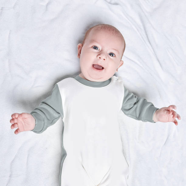 istock cute kid in a penguin suit lying on a blanket. 1188934855