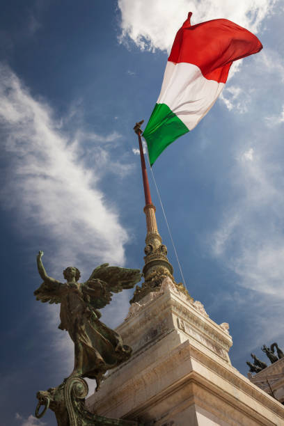 Vertical low angle view of the Italian flag fluttering at Il Vittoriano, Vittorio Emmanuelle II National Monument, Piazza Venezia, Rome