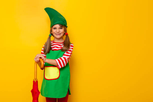 istock Child dressed as Christmas elf holding an umbrella 1188943709
