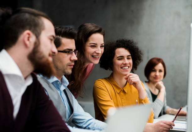 istock Group of young businesspeople working together in office, talking. 1188943782
