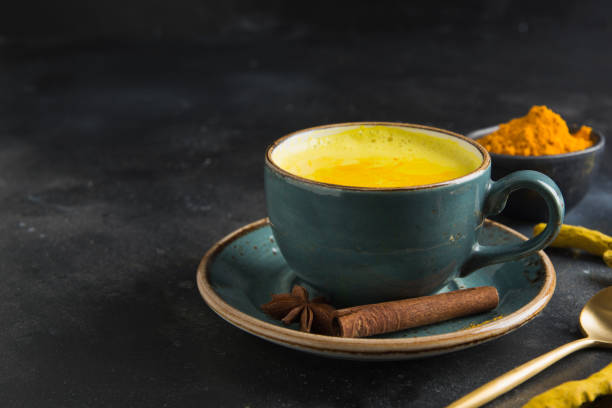 cup of golden turmeric latte milk on dark. close up. - cardamom indian culture food spice imagens e fotografias de stock