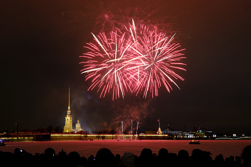 New Year's colorful night fireworks in honor of the New Year and Christmas celebrations in the historic center against the backdrop of the Peter and Paul Fortress.