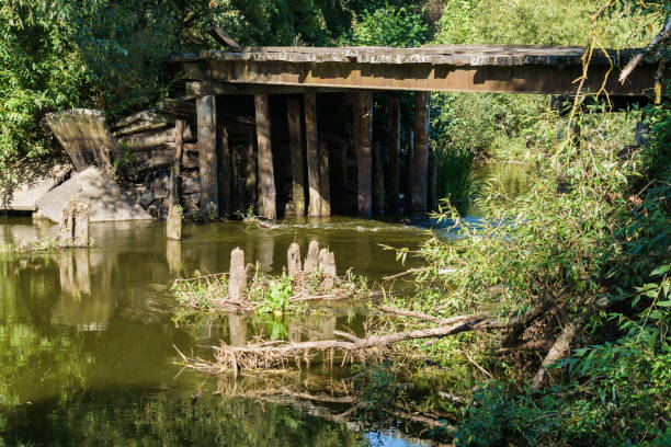 istock Old dilapidated wooden bridge over the river. 1188946039