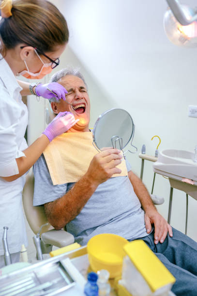 istock Mature man having toothache at dentist 1188947675