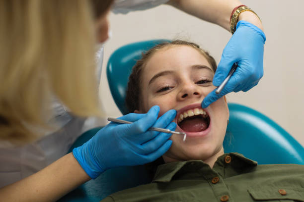 istock Dentist doing teeth checkup of little girl. 1188948526