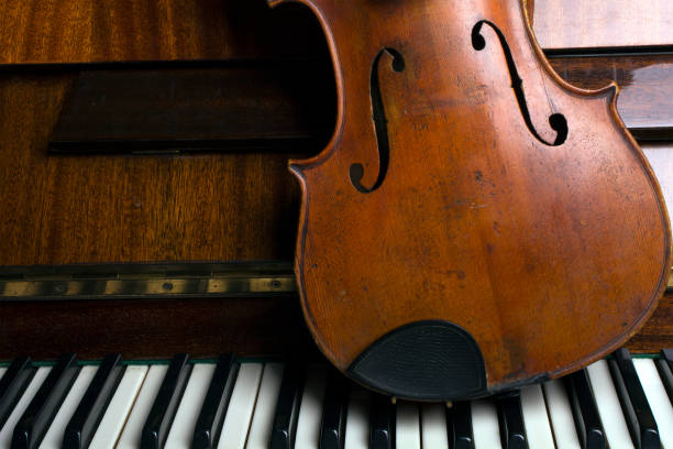 istock old violin on the piano 1188948735