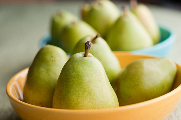 Pears in Bowls  bartlett pear stock pictures, royalty-free photos & images