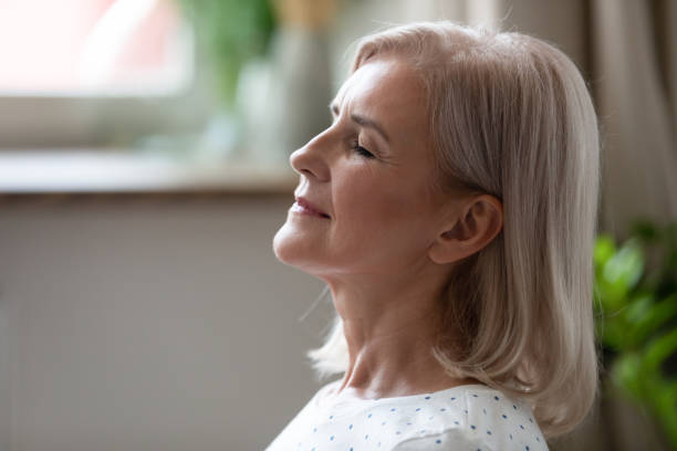 istock Calm serene middle aged woman breathing with eyes closed 1188952105