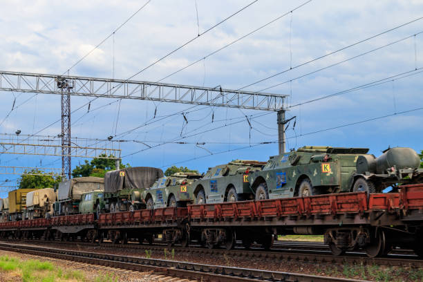 istock Cargo train carrying military vehicles on railway flat wagons 1188956338