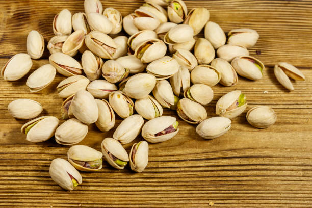 istock Pistachio nuts on a wooden table 1188958725