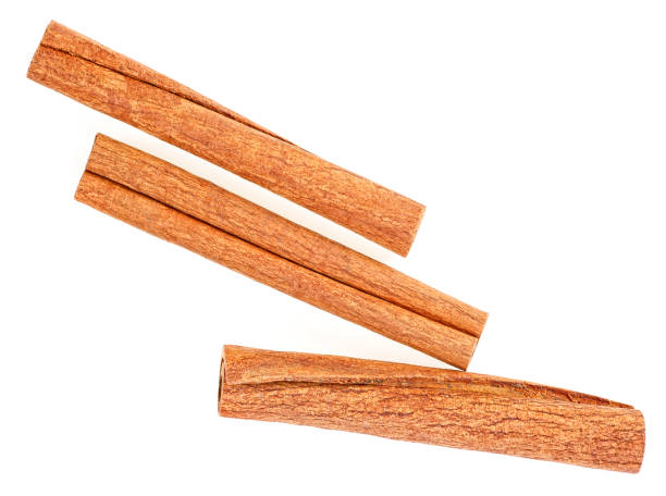 istock Cannelle. Three cinnamon sticks isolated on a white background, top view. 1188959737