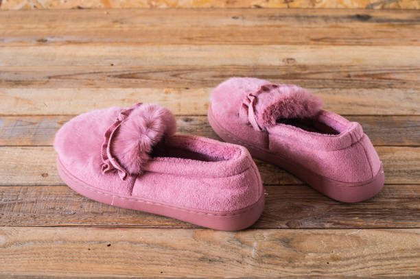 istock Slippers on wood background 1188960103
