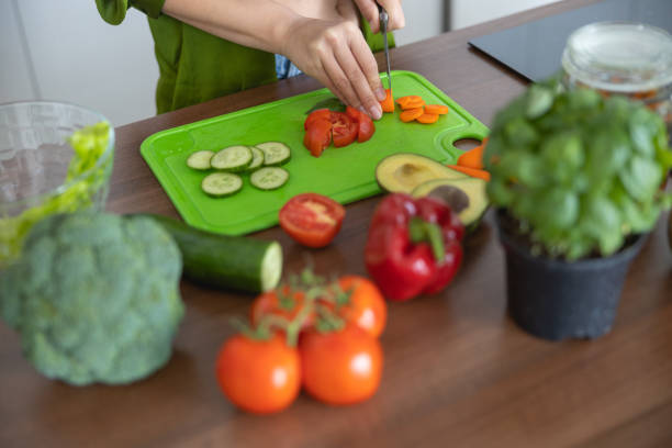 istock Female cook preparing ingredients for a soup 1188960861