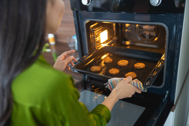 istock Girl looking at the biscuits on the baking tray 1188961518