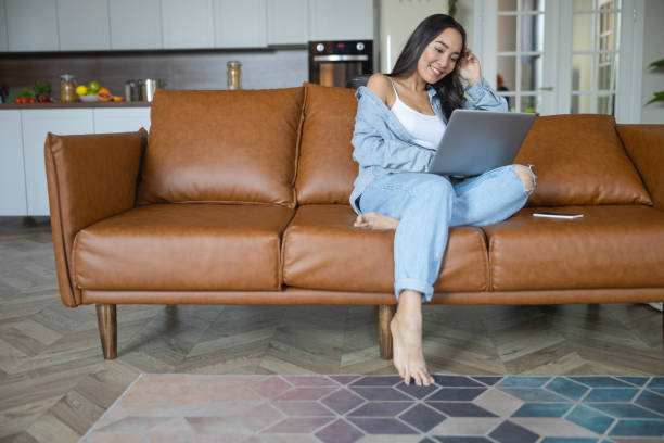 istock Smiling young woman relaxing on the couch 1188961593