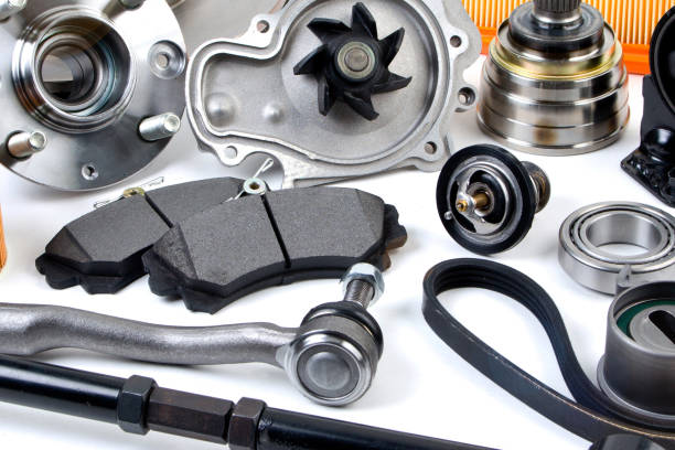 istock Auto parts background. Hub, pump, brake pads, filter, timing belt, rollers, constant velocity joints, thermostat and other on white background. Set of spare parts for repair 1188961594