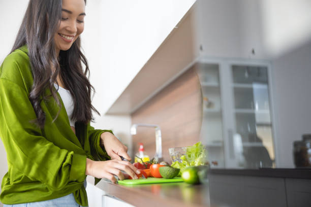 istock Smiling female preparing vegetables for a sauce 1188961921