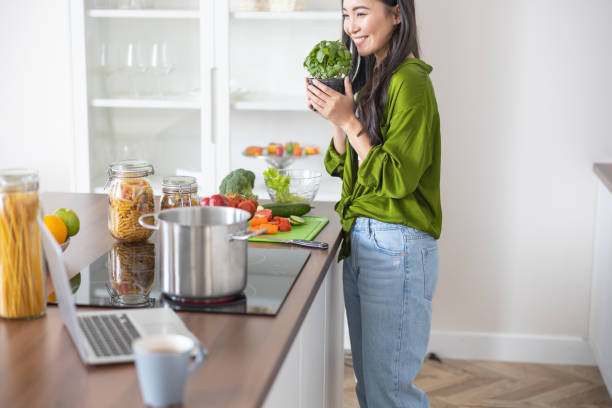 istock Young lady holding a pot of basil 1188961973
