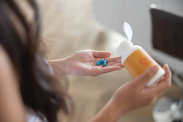 istock Girl with vitamin capsules on her palm 1188962049