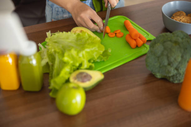 istock Female hands cutting vegetables on the table 1188962109