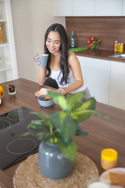 istock Pleased young female with a crescent roll 1188962187