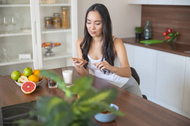 istock Female smearing her bread with almond butter 1188962524