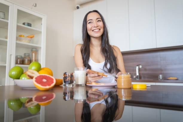 istock Young pretty woman preparing snack at home 1188962542
