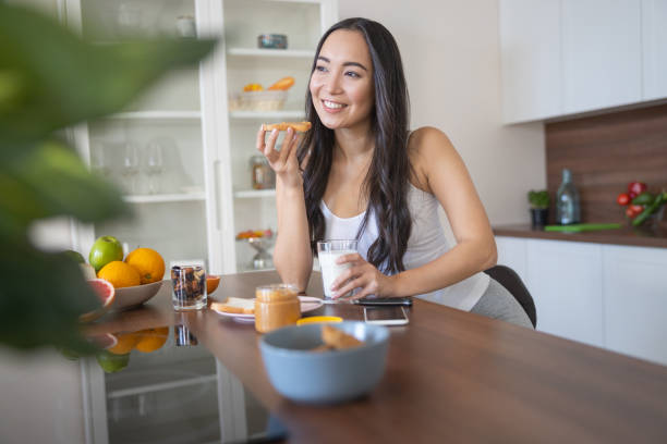 istock Young pleased pretty female drinking cows milk 1188962587