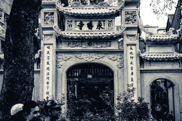 Hanoi, Vietnam - May, 2019: Traditional Vietnamese architecture was heavily influenced by Chinese architecture, with some unique additions, such as the predominance of wood as opposed to brick. Hanoi is still filled with traditionally styled buildings, some preserved and others showing significant signs of decay.